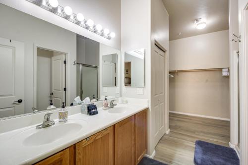 a bathroom with two sinks and a large mirror at Tucson Condo Rental with Balcony and Mountain View! in Tucson
