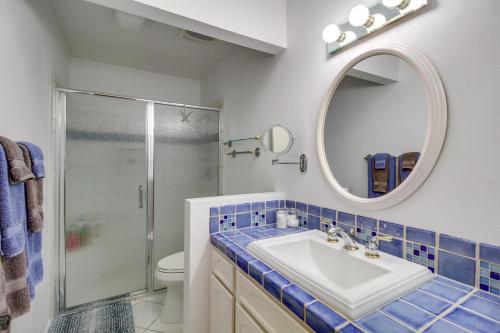 a bathroom with a sink and a mirror and a shower at Tucson Townhome with Shared Pool in 55 and Community! in Tucson