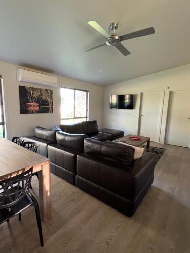 a living room with a couch and a ceiling fan at Greenways Holiday Units in Tocumwal