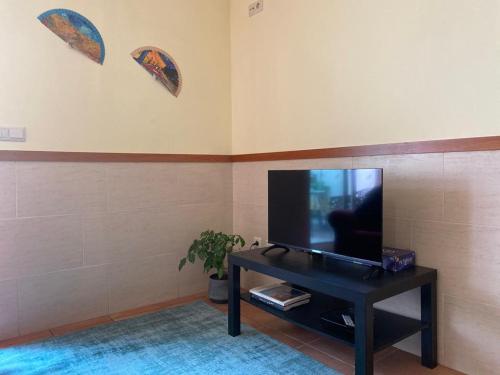 uma sala de estar com uma televisão de ecrã plano sobre uma mesa em Cávado Terrace Studio em Parada de Tibães