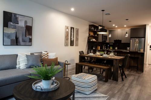 a living room with a couch and a table at Selkirk Staytion - Stylish Condo with Hot Tub in Revelstoke