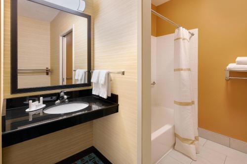 a bathroom with a sink and a mirror at Fairfield Inn & Suites Austin University Area in Austin