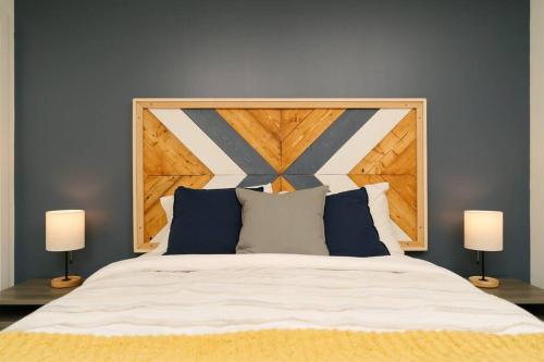 a bedroom with a large bed with two lamps at The Nest - Condo with Hot Tub & BBQ in Revelstoke