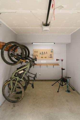 a bike hanging on a wall in a room at The Nest - Condo with Hot Tub & BBQ in Revelstoke