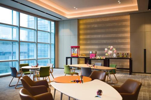 a restaurant with tables and chairs and large windows at Shenzhen Marriott Hotel Nanshan in Shenzhen
