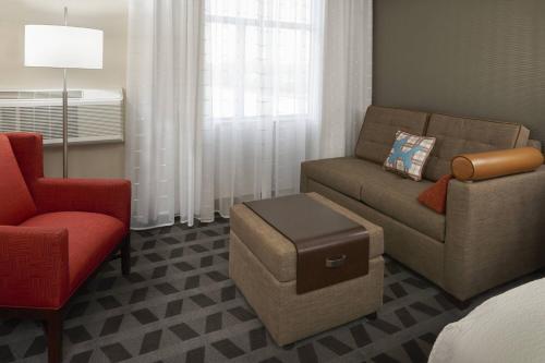 a living room with a couch and a chair at TownePlace Suites by Marriott Oshawa in Oshawa