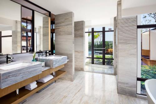 a bathroom with two sinks and a large mirror at Xiamen Marriott Hotel & Conference Centre in Xiamen