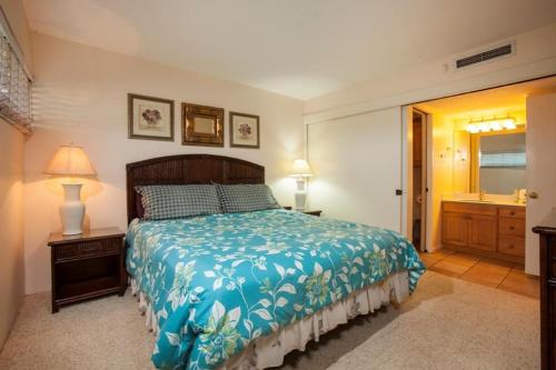 a bedroom with a bed and a bathroom with a sink at Sugar Beach 317 - MCH in Kihei