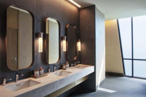 a bathroom with three sinks and three mirrors at The Joseph, a Luxury Collection Hotel, Nashville in Nashville