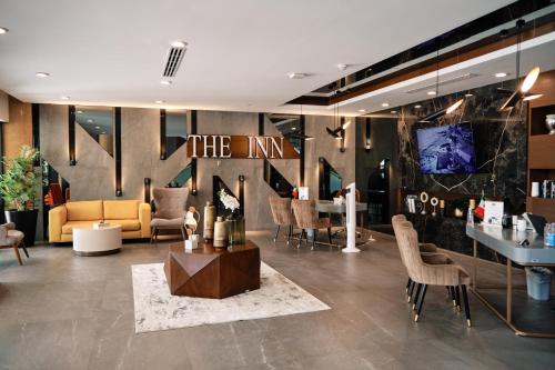 a lobby with a couch and a table and chairs at The Inn at Mazatlan in Mazatlán