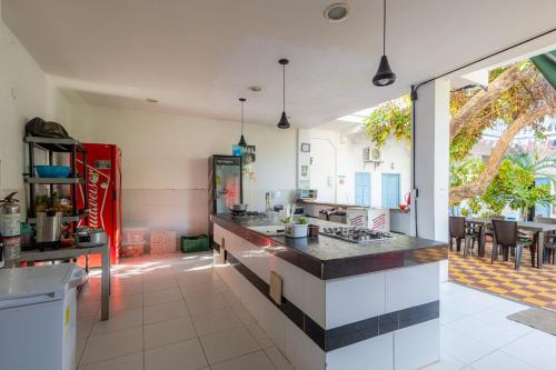 uma grande cozinha com um balcão e uma mesa em Media Luna Hostel Cartagena em Cartagena das Índias