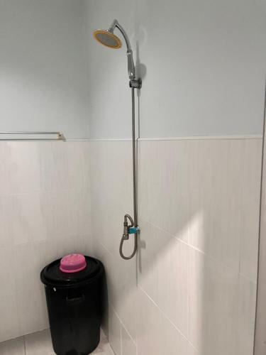 a shower in a bathroom with a black trash can at Phangan Dream box in Baan Tai