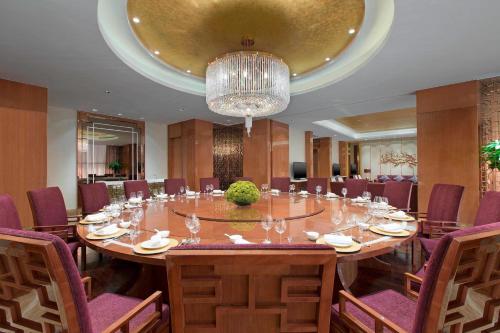 a large conference room with a large table and chairs at Sheraton Grand Wuhan Hankou Hotel in Wuhan