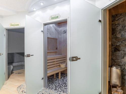 a bathroom with two sliding doors in a room at Flat in Hohentauern near the ski area in Hohentauern