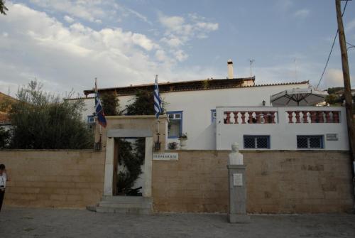a white building with flags on top of it at Ippokampos in Hydra