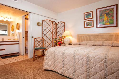a bedroom with a bed and a bathroom with a sink at Sugar Beach 223 - MCH in Kihei