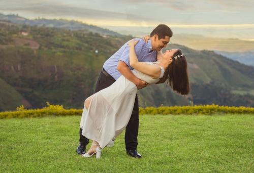a man and a woman dancing in a field at Hotel Kasama in San Agustín
