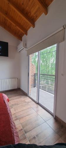 a room with a large sliding glass door with a view at Complejo Boulevard Plottier in Plottier