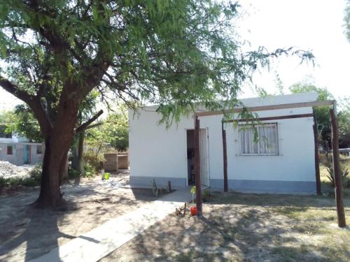 a white building with a tree in front of it at Casa de campo en la ciudad in Chumillo