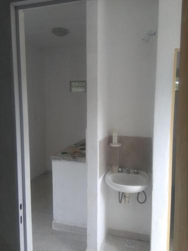 a white bathroom with a sink and a counter at Casa de campo en la ciudad in Chumillo