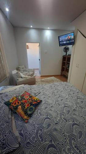 a bedroom with a bed with a pillow on it at Aconchego na Villa in São João del Rei