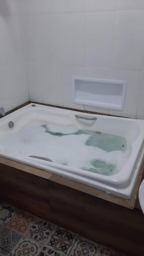 a white sink in a bathroom with a glass counter at Aconchego na Villa in São João del Rei