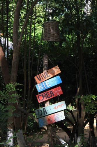 a street sign with different signs on it at Cabañas La Escondida Mazunte in Mazunte