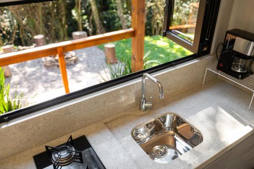 a kitchen counter with a sink and a window at Container Perlage in Garibaldi