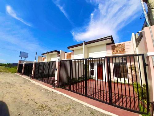 a fence in front of a house at Lemoons Apartelle in Tagum