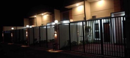 a fence in front of a building at night at Lemoons Apartelle in Tagum