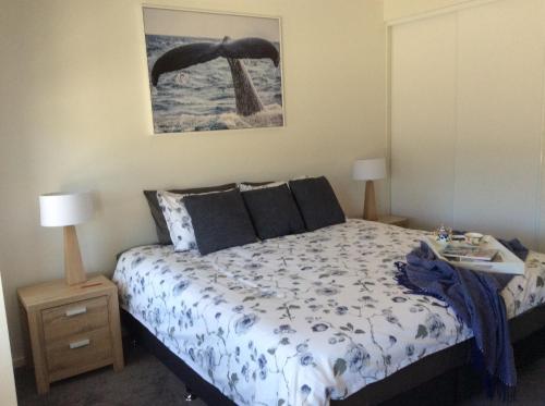 a bedroom with a bed and a picture on the wall at WhaleEscape Portland in Portland