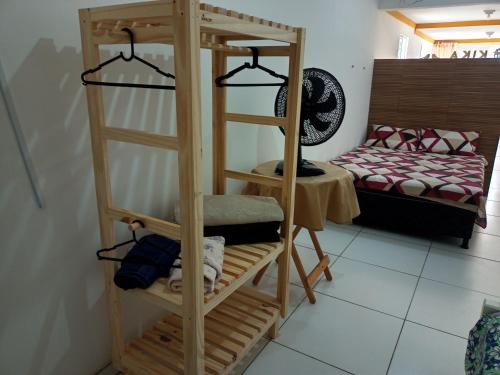 a wooden bunk bed in a room with a bed at Aconchego da Kika in Caruaru