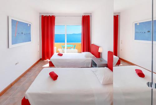 a hotel room with two beds and a window at Glyfa Corfu Apartments in Barbati
