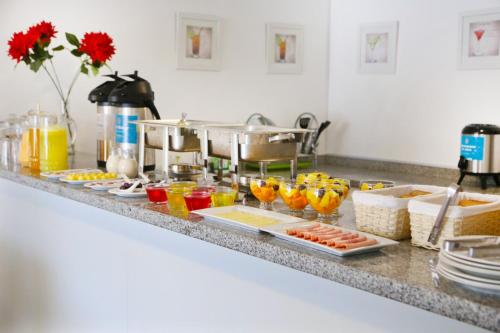 a kitchen counter with many different types of food at Hoteles Riviera Ejecutivo in Arequipa