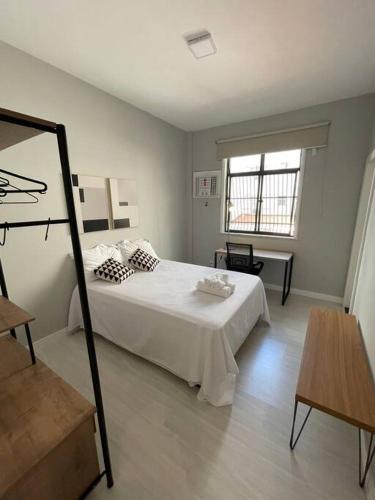 a bedroom with a white bed and a mirror at LEBLON QUADRA DA PRAIA 3 Quartos in Rio de Janeiro