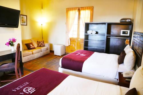 Ένα ή περισσότερα κρεβάτια σε δωμάτιο στο Hoteles Riviera Colonial