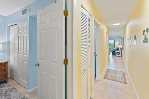 a hallway with a white door and a hallway with a hallway at South Seas Beach Villa 2412 condo in Captiva
