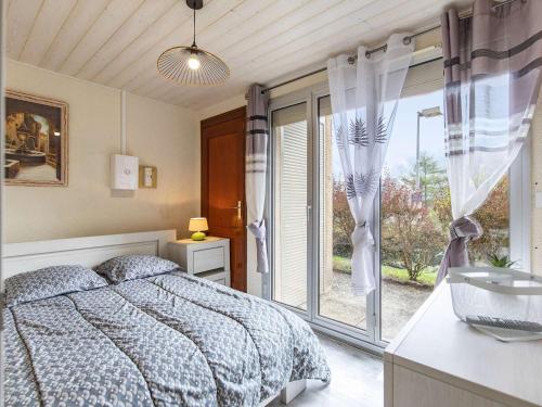 a bedroom with a bed and a large window at Chalet Cauterets, 3 pièces, 8 personnes - FR-1-401-269 in Cauterets