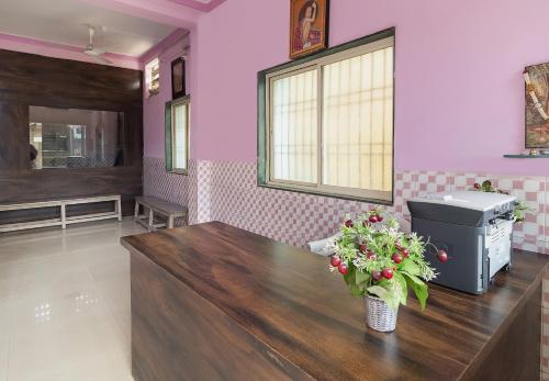 a hair salon with a table with flowers on it at SPOT ON Shree Gajanan in Aurangabad