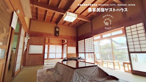 a room with a table in a room with windows at INASHIKI NEST in Inashiki