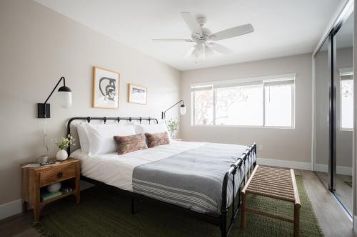 a bedroom with a bed and a ceiling fan at Seashore VII by AvantStay Modern La Jolla Flat 5mins from the Beach in San Diego