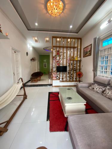 a living room with a couch and a red rug at Villa homestay Misa in Phan Thiet