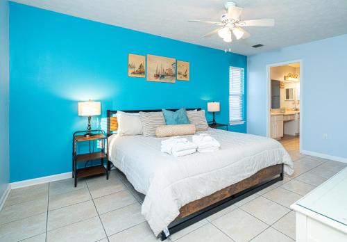 a blue bedroom with a bed and a blue wall at PALM COVE VACATION HOME- One level, Community pool, Pet Friendly in Panama City Beach