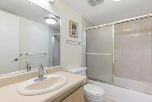 a bathroom with a sink and a toilet and a shower at Kihei Surfside 613 - MCH in Kihei