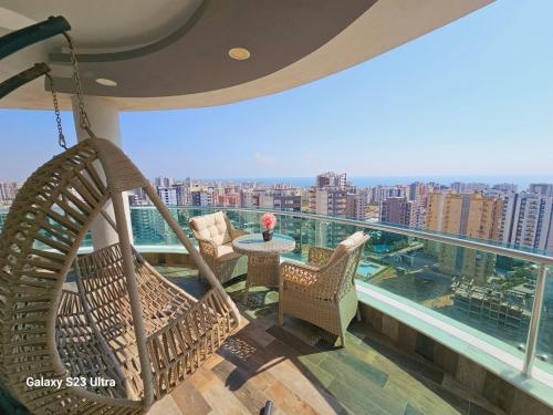 a balcony with hammocks and a view of a city at luxury house at mezitli in Mezitli