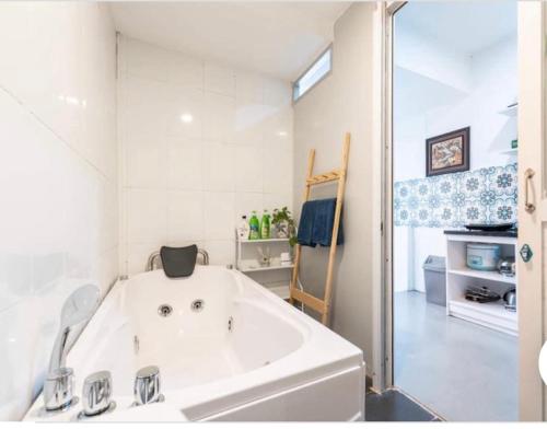 a large white bath tub in a white bathroom at Duplex WARM HANOI, 2 bedrooms, Old Quarter, 3mins to Hoan Kiem Lake in Hanoi