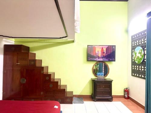 a living room with a staircase and a television at Warm Hanoi, near Hoankiem Lake, 2Brs, Old Quarter in Hanoi