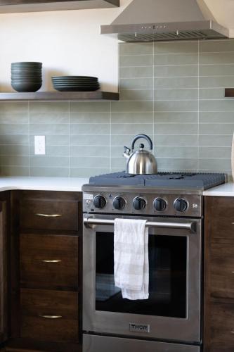 a kitchen with a stove with a tea kettle on it at Manzanita Rest in Mariposa