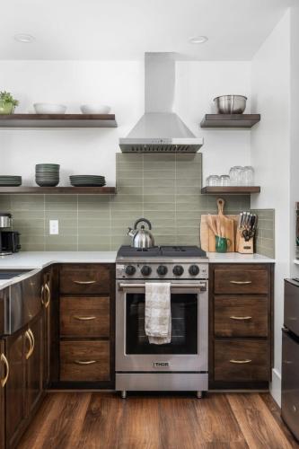a kitchen with stainless steel appliances and wooden cabinets at Manzanita Rest in Mariposa