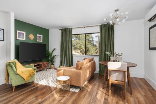 a living room with a couch and a tv at Manzanita Rest in Mariposa